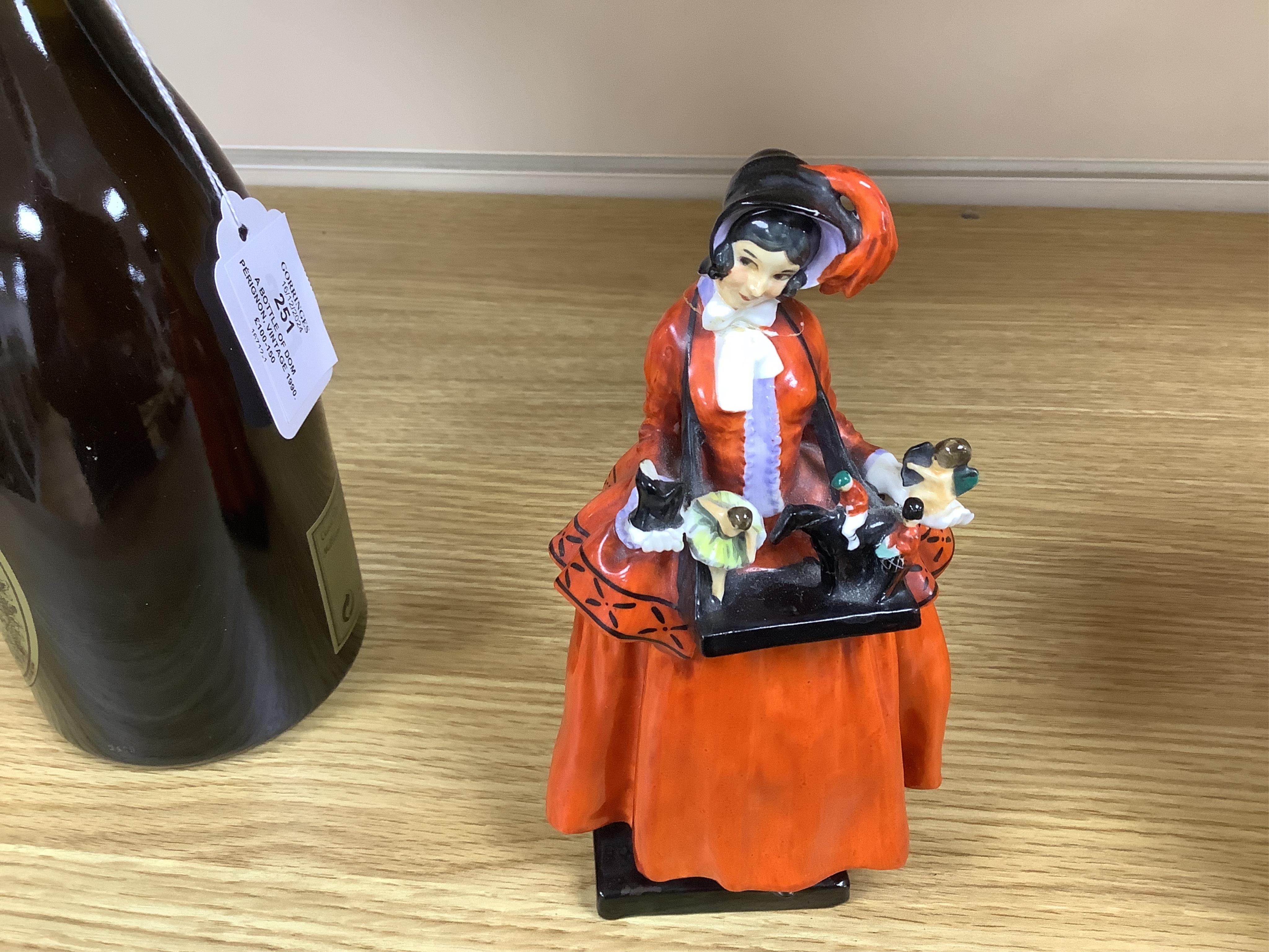 Eight Royal Doulton and 19th century German figures, including two Sitzendorf frog musicians, a Royal Doulton Celia (HN1727) and the toy seller. Condition - fair to good, substantial cracks and damage to the Celia figure